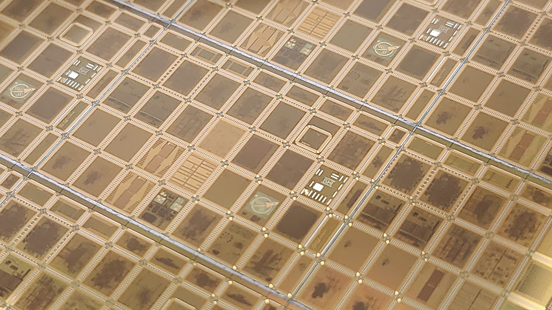 Close-up of the wafer.space Run 1 wafer with multiple silicon designs
